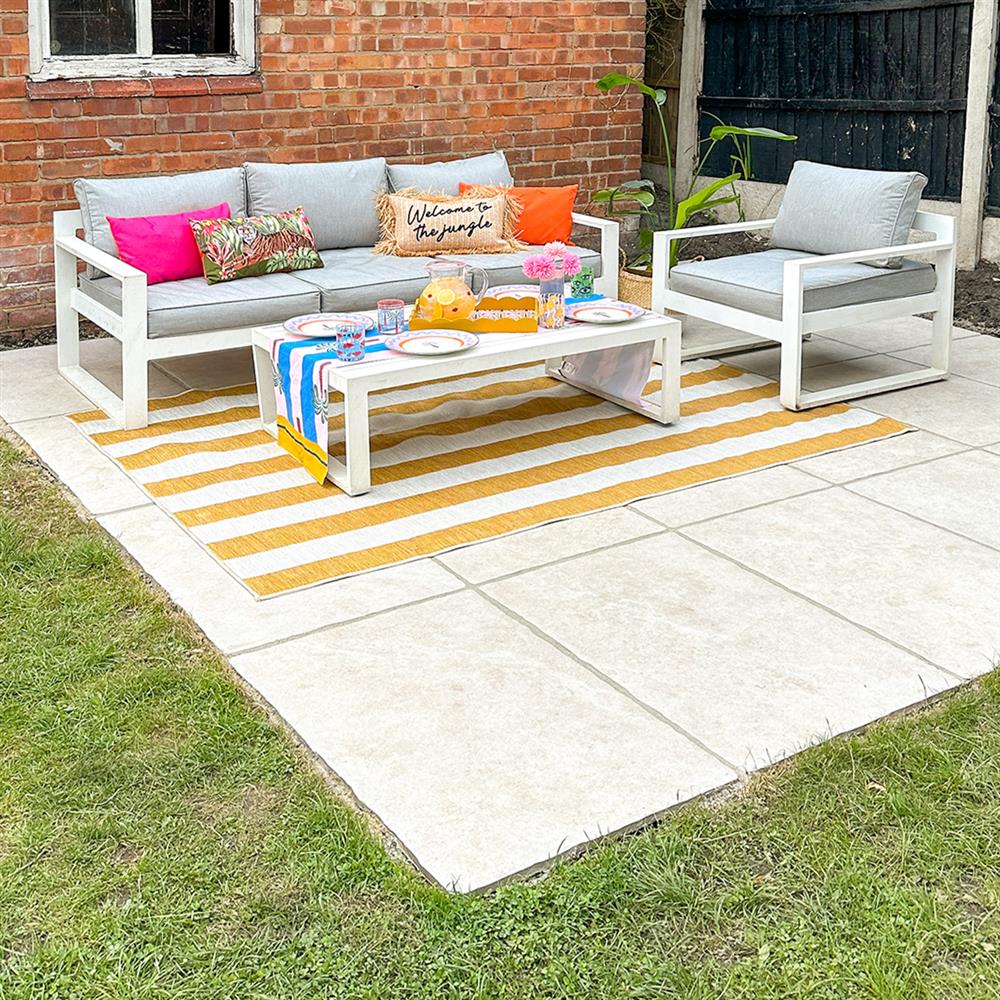 Kensington beige porcelain paving garden patio with lounge furniture